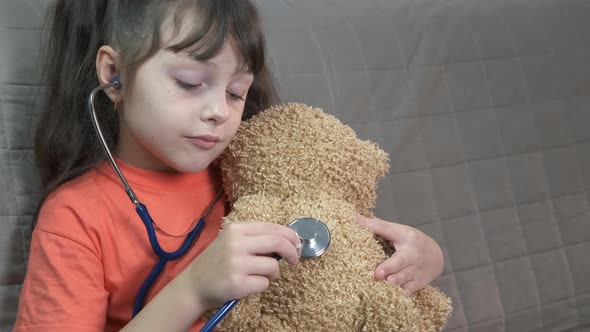 Practicing doctor with teddy bear.  alt