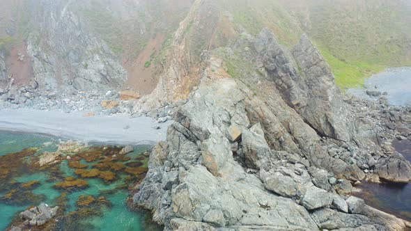 A Beautiful Rocky Cape on Askold Island Shrouded in Morning Mist alt