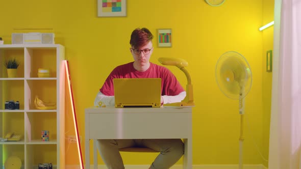 Student Is Working On Yellow Laptop