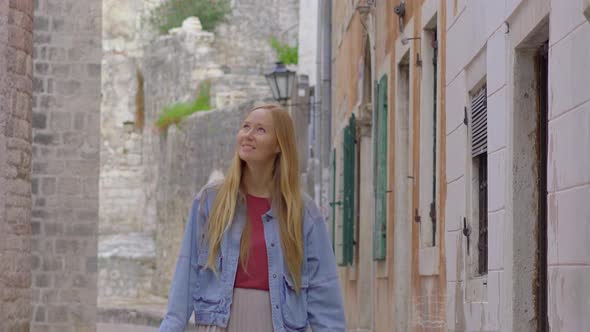 A Young Woman Visits the Old Town of Kotor in Montenegro alt