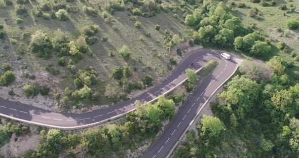 Aerial Top Down  View of Cars Driving on a Curvy Road on the Mountain