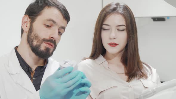 Young Beautiful Woman Talking to Her Dentist After Teeth Checkup alt