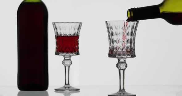 Rose Wine. Red Wine Pour in Wine Glass Over White Background alt