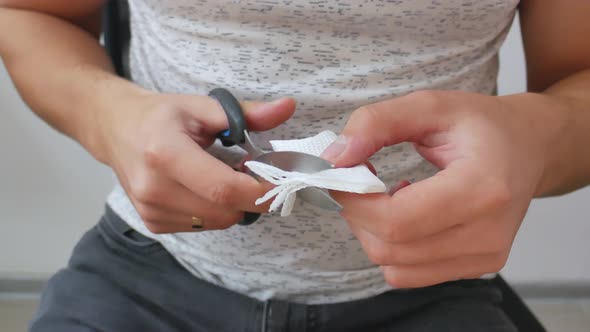 Closeup Man Cutting Paper with Scissors