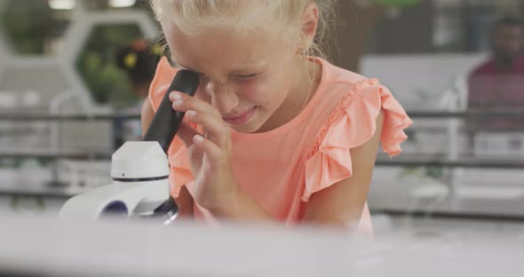 Video of happy caucasian girl with microscope during lesson alt