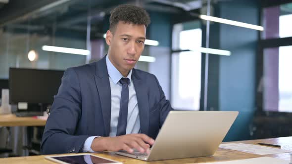 Attractive Young Businessman Saying No By Finger in Office alt