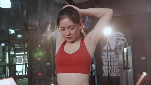 Asian Young Sportswoman stretching her body in the gym.  fitness, sports concept.