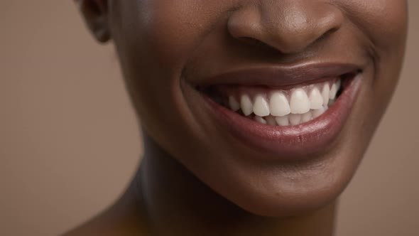 Cropped Shot Of African American Woman Smiling Over Beige Background alt