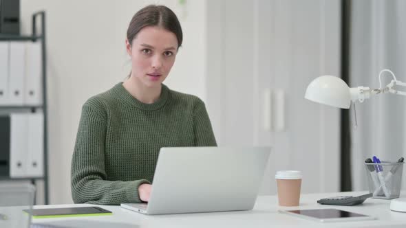 Young Woman with Laptop Smiling at Camera alt