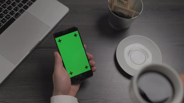 Mobile Phone with Green Screen Chroma Key Laying Near on the Table alt