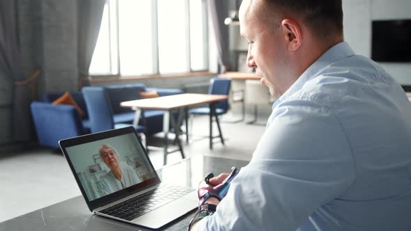 Disabled cyborg man with artificial hand limb talks to aged lady doctor at online consultation alt