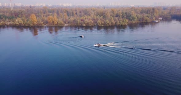 Flight Over the River with Floating Boats with Windsurfing and Views of the Island Autumn