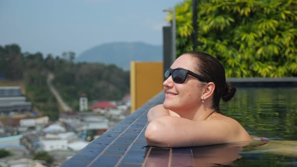 Girl Looks at Picturesque Hilly Landscape with Green Trees