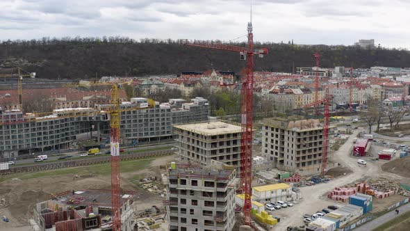 Workers on rooftop of unfinished building at construction site, Prague. alt