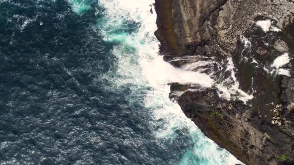 Aerial view of water encountering agitated Atlantic ocean, Faroe island. alt