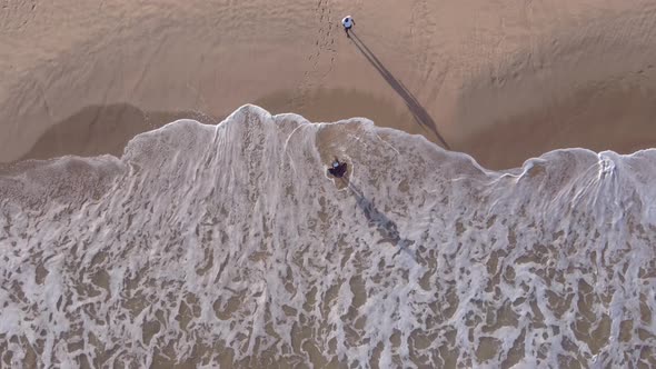 Drone Flying Over Couple That's Having a Moment at the Beach