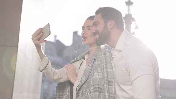 Happy Couple Making Photo On Phone Outdoors alt