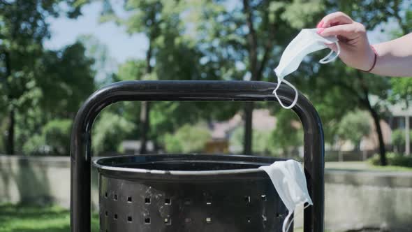 People throw used medical masks into trash bin, pollution by disposable masks. alt