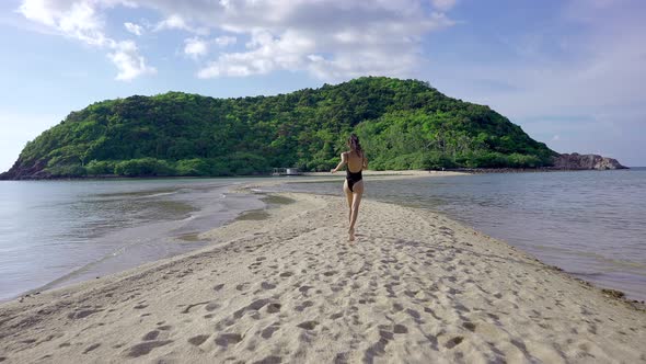 Pretty Woman in Black Swimsuit Running Alone on a Sandbar Slow MotionThailand
