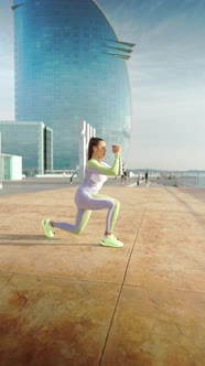 Female Athlete Squatting on Embankment alt