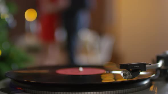 Vinyl Record Playing and Unrecognizable Couple Dancing at Christmas alt