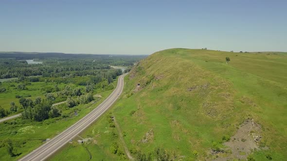 Aerial: Flying Over the Highway Among the Mountains alt