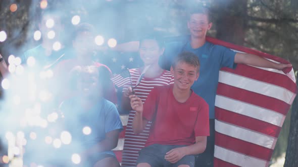 Kids watching fireworks and waving flags on Fourth of July