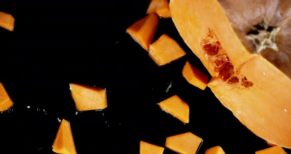 Sliced Pumpkin Falls To the Water with a Splash. alt
