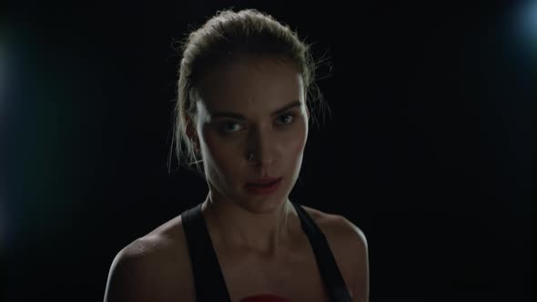 Sport Woman Doing Punches in Red Boxing Gloves at Cardio Training. Woman Boxer alt