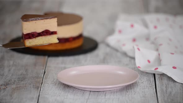 Woman Baker is Putting a Piece of Cherry Cake with Caramel Mousse on a Pink Plate