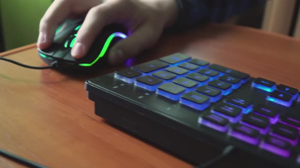 Young Gamer Plays a Video Game Uses Gaming Illuminated Keyboard alt