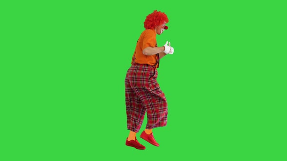 Happy Clown Show Thumbs Up While Walking on a Green Screen Chroma Key alt