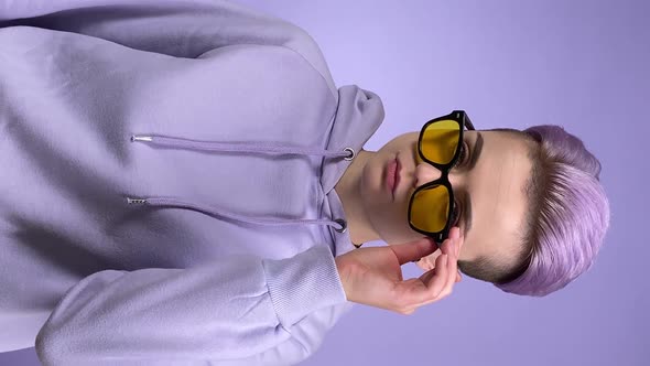 Vertical Shot Young Woman Lowering Sunglasses Folding Arms Crossed alt