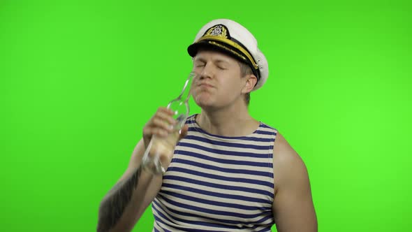 Young Sailor Man Drinks Vodka. Seaman Guy in Sailor's Vest Shirt. Chroma Key alt
