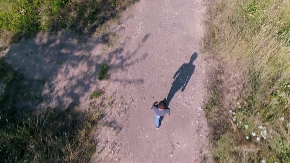Man Alone Walking A Path Aerial Drone Shot Top Down