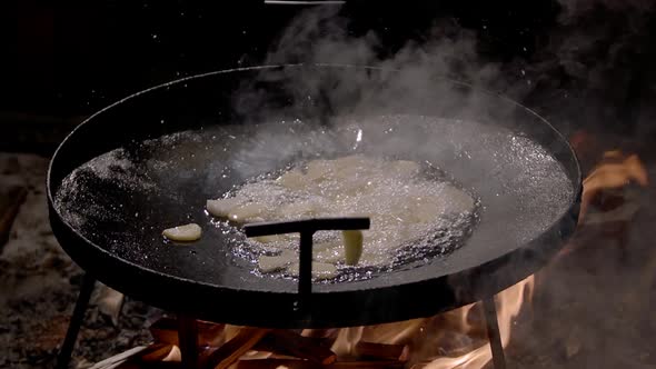 Slow Motion Potatoes are Poured Into a Frying Pan for Cooking