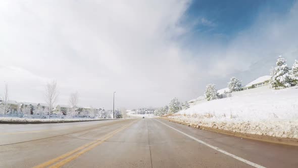 Driving on suburban road after the Sping snow storm. alt