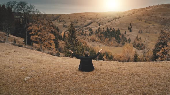 Business Man Riseup Hands at Sun Mountain Aerial alt