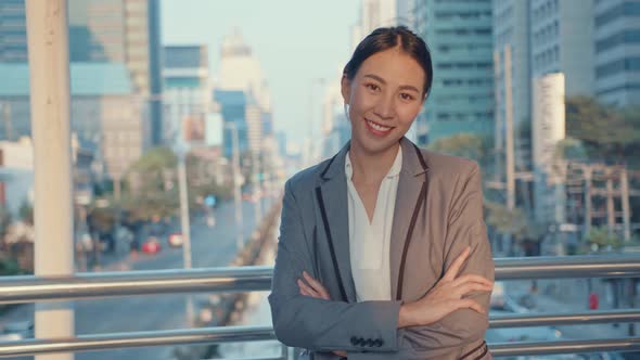 Asia businesswoman in fashion office clothes smiling and looking at camera while happy.
