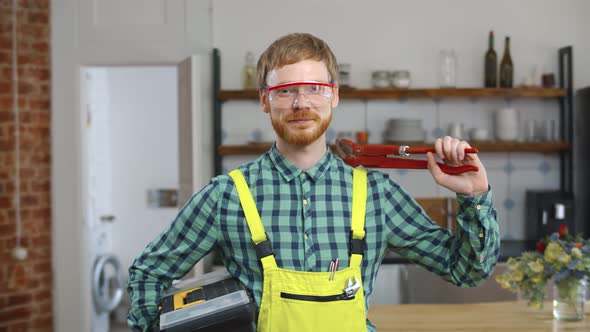 Young Plumber with Equipment in Uniform Posing at Camera alt