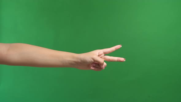 Woman's Hand Is Show Two Fingers Up On Green Screen Background alt