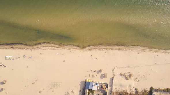 Sandy Beach with Sunbathing Tourists View From Drone alt