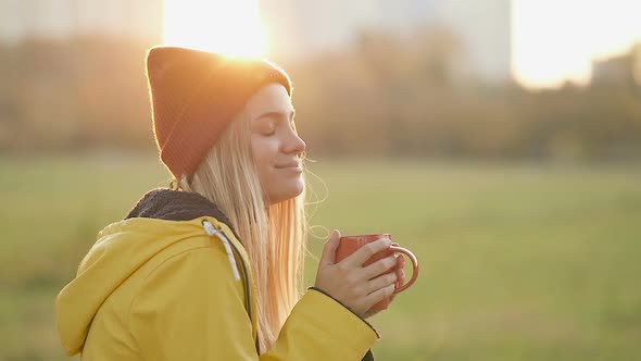 Smiling Woman Drinking Coffee from Red Cup