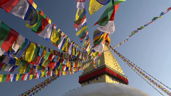 Colorful Flags with Buddhist Scriptures Inscribed on Them Hanging Tied To the Boudhanath Stupa alt