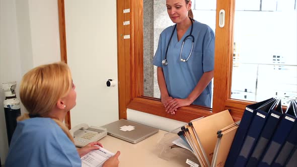 Female intern giving a folder alt