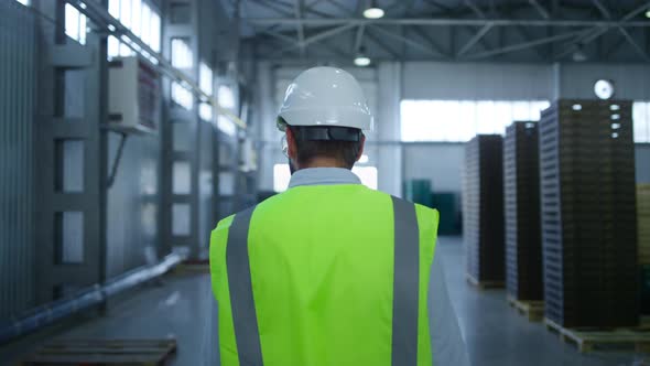 Back View Warehouse Worker Inspecting Product Pallets Shipment Process Checking alt