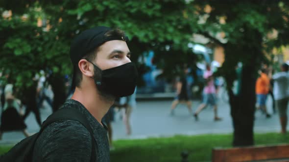 Masked Face of Guy in Crowd of Political Opposition of Coronavirus Restrictions