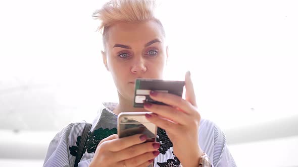 Close Up Hands Holding Credit Card and Using Mobile Smart Phone Indoor, Online Shopping, Woman Happy alt