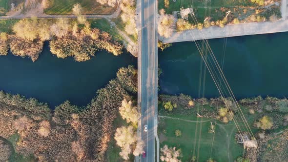 Traffic on the bridge over a small river. Video shot with a bird's-eye view