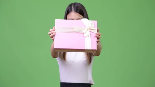 Young Beautiful Asian Businesswoman Giving Gift Box